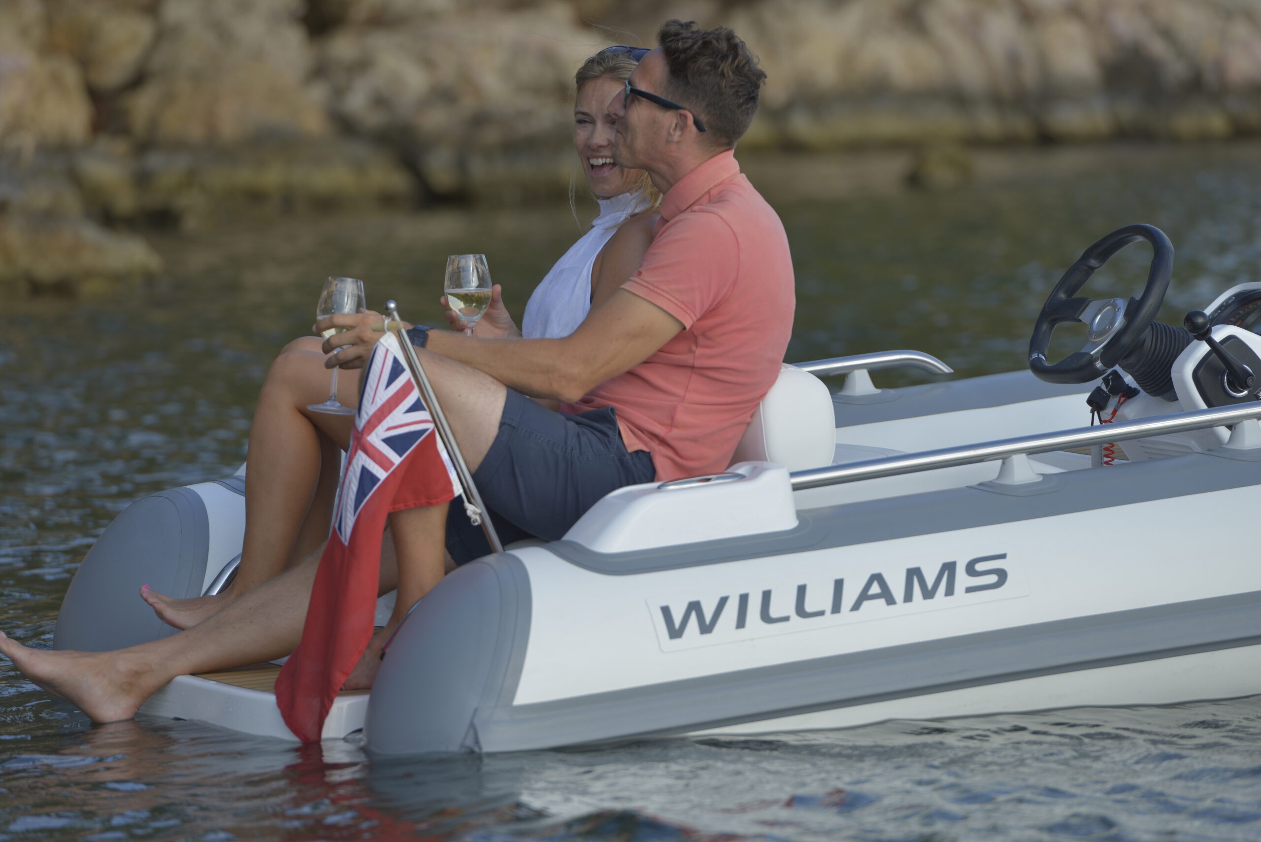 Passengers relaxing in a white rigid yacht tender.