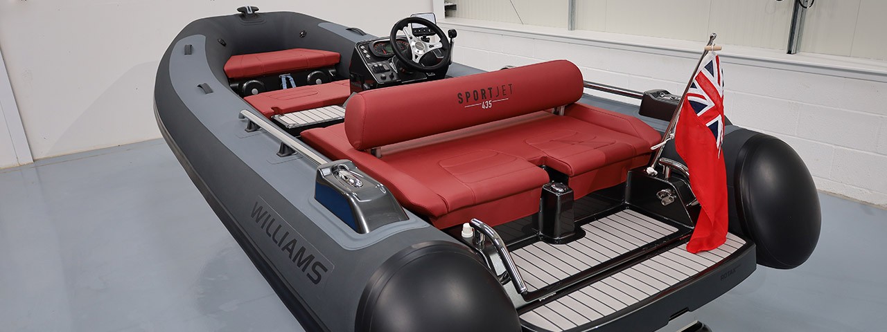 Williams SportJet 435 tender with luxurious features, including premium red seating and a British flag, designed for ultimate comfort and performance